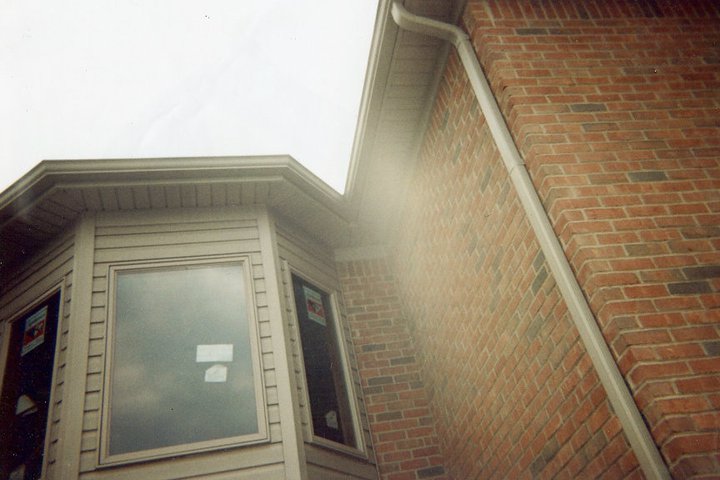 A brick house with white gutters