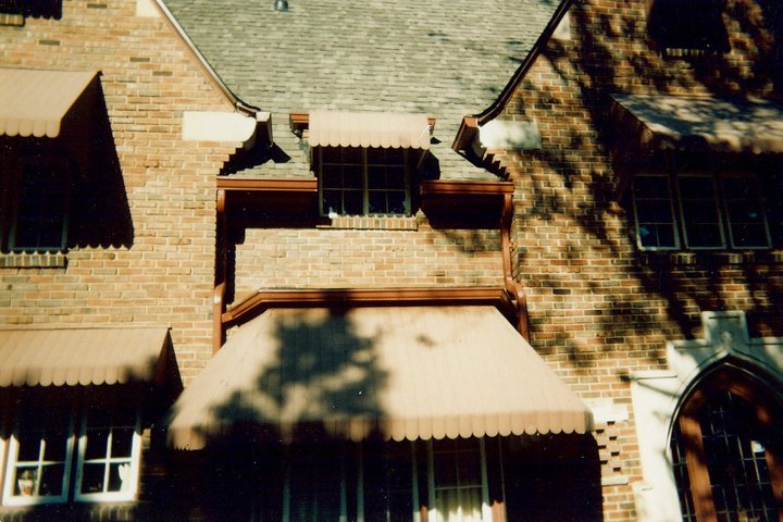 A brick house with matching red gutters
