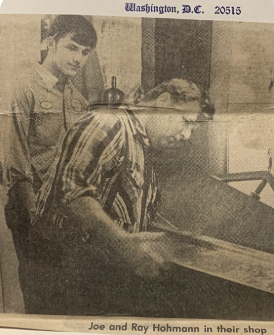 A newspaper clipping depicting Joe and Ray Hohmann in their shop
