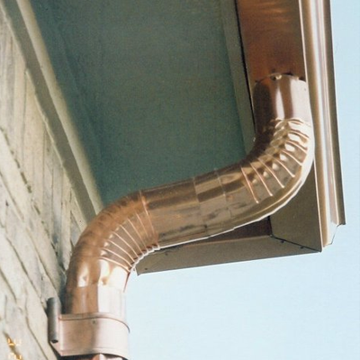 A shiny metal downspout